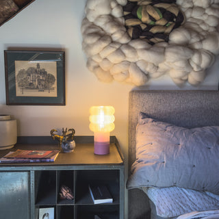 Room interior with a bed, nightstand, and decorative elements.