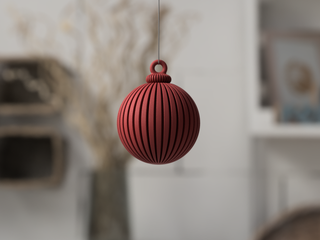 Red textured ball hanging against a blurred indoor background