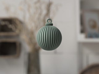 Green textured ball hanging against a blurred indoor background